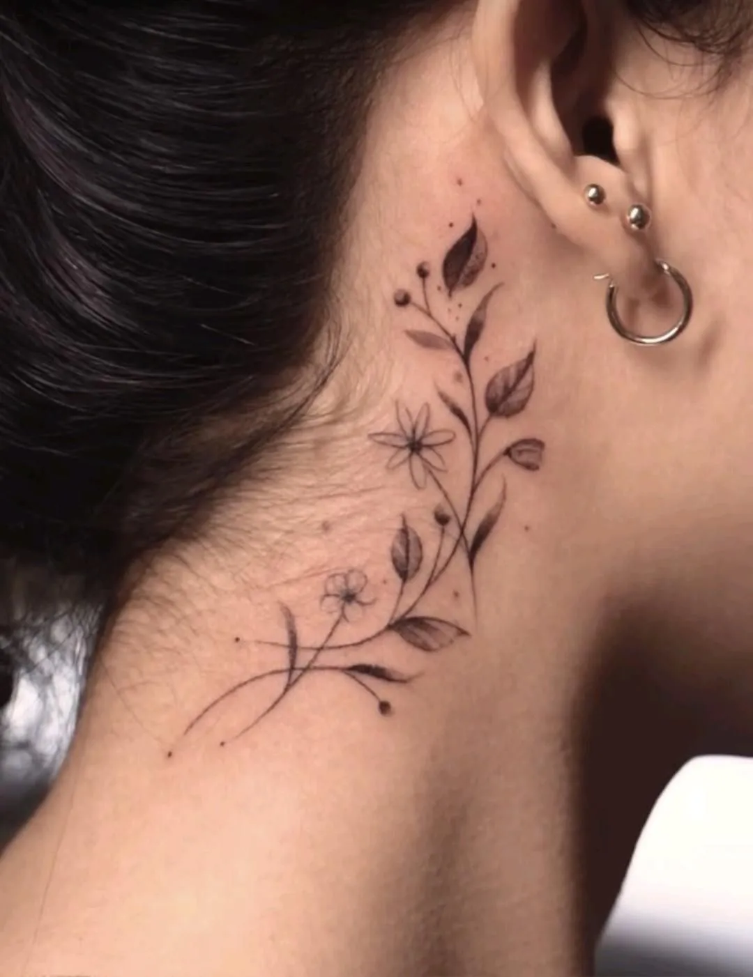 Make a statement with a design extending into a neck tattoo placement, ideal for cascading floral or ornamental art.