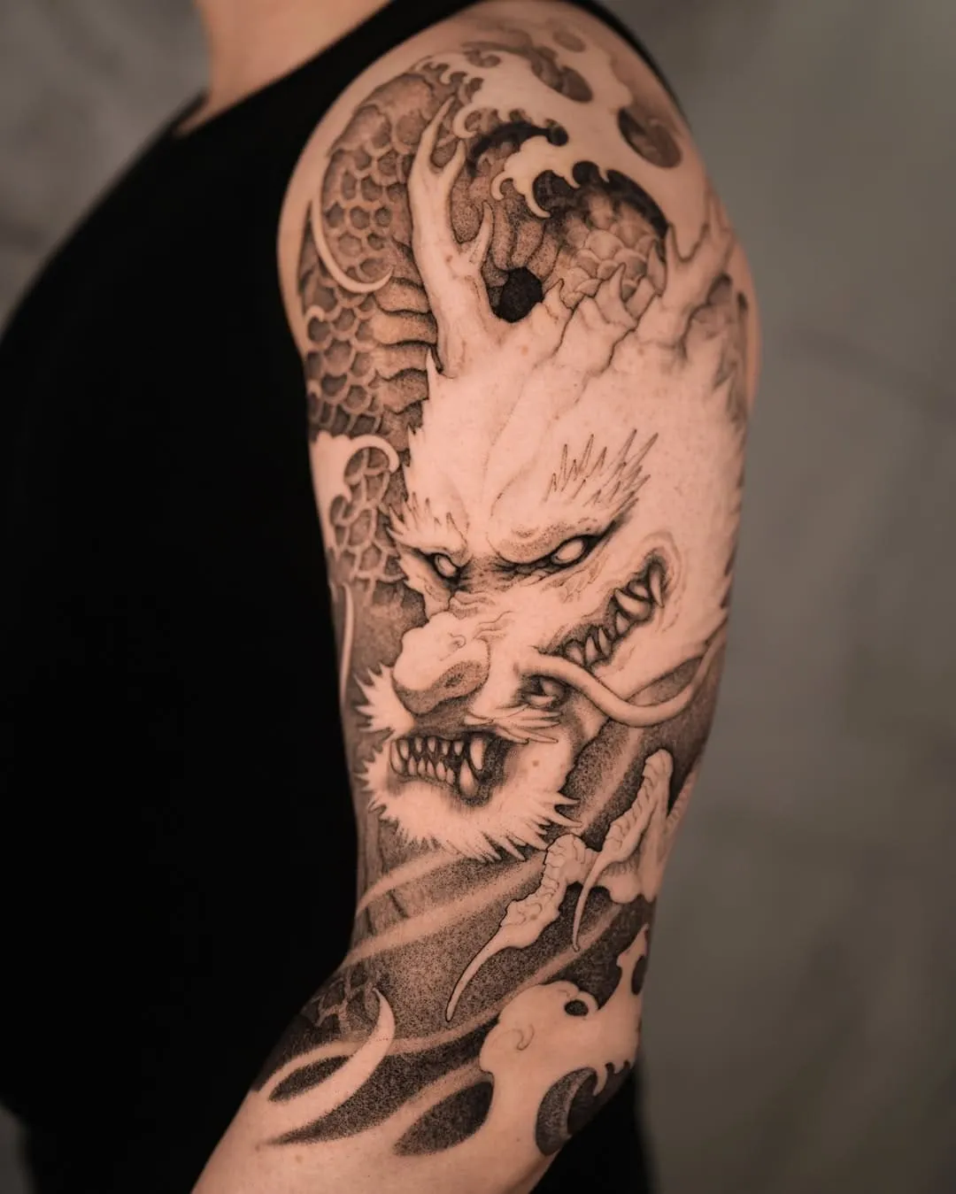 A black and white traditional Japanese tattoo of a dragon