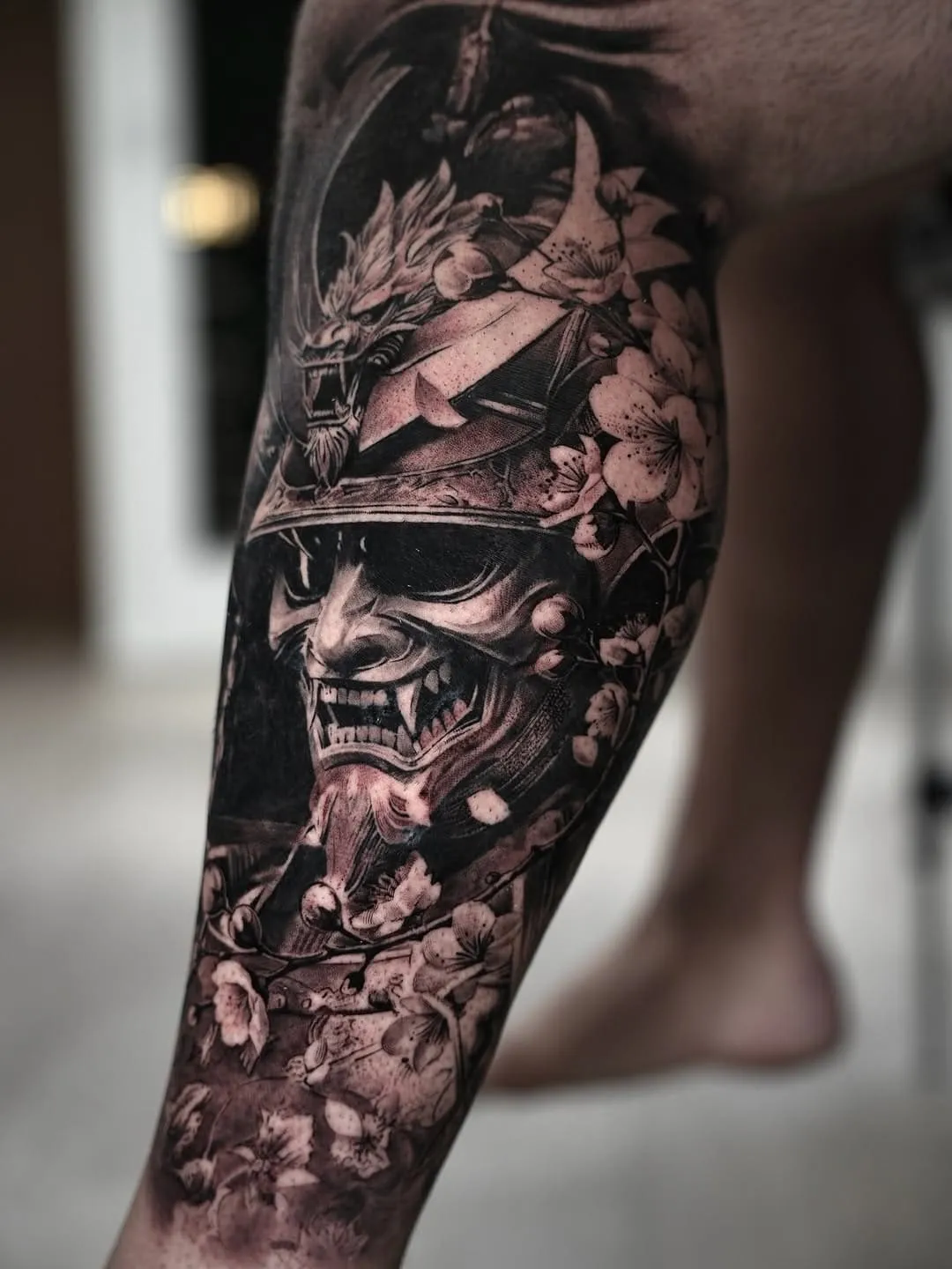 Black and white traditional Japanese tattoo on the calf