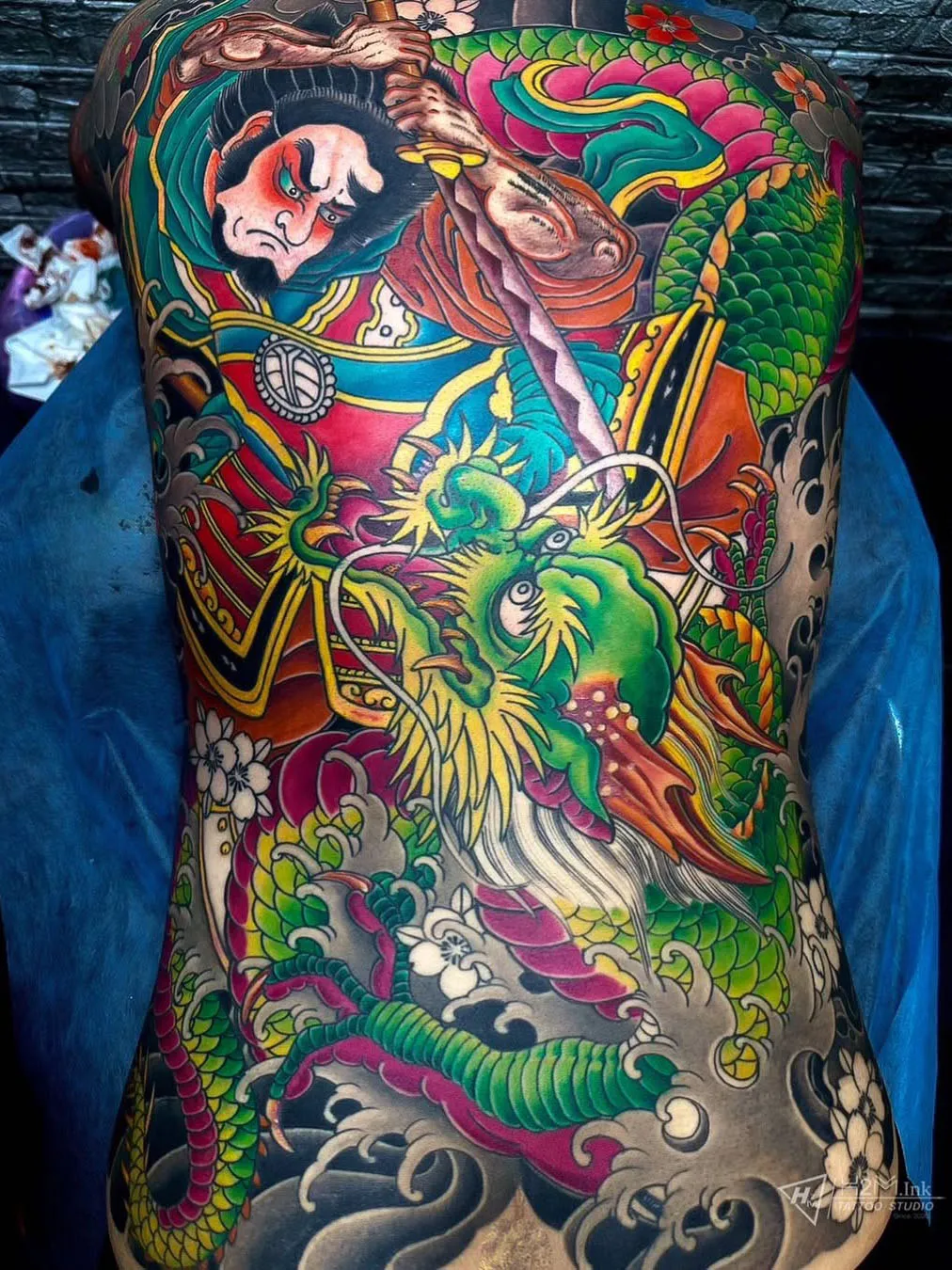 Full back traditional Japanese tattoo with samurai and dragon
