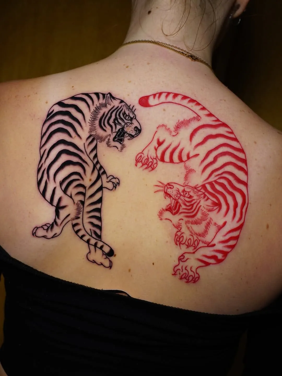Half back Japanese tattoo with two ferocious tigers