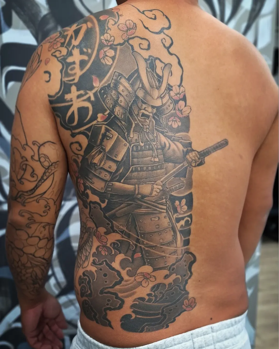 Half back Japanese tattoo with samurai