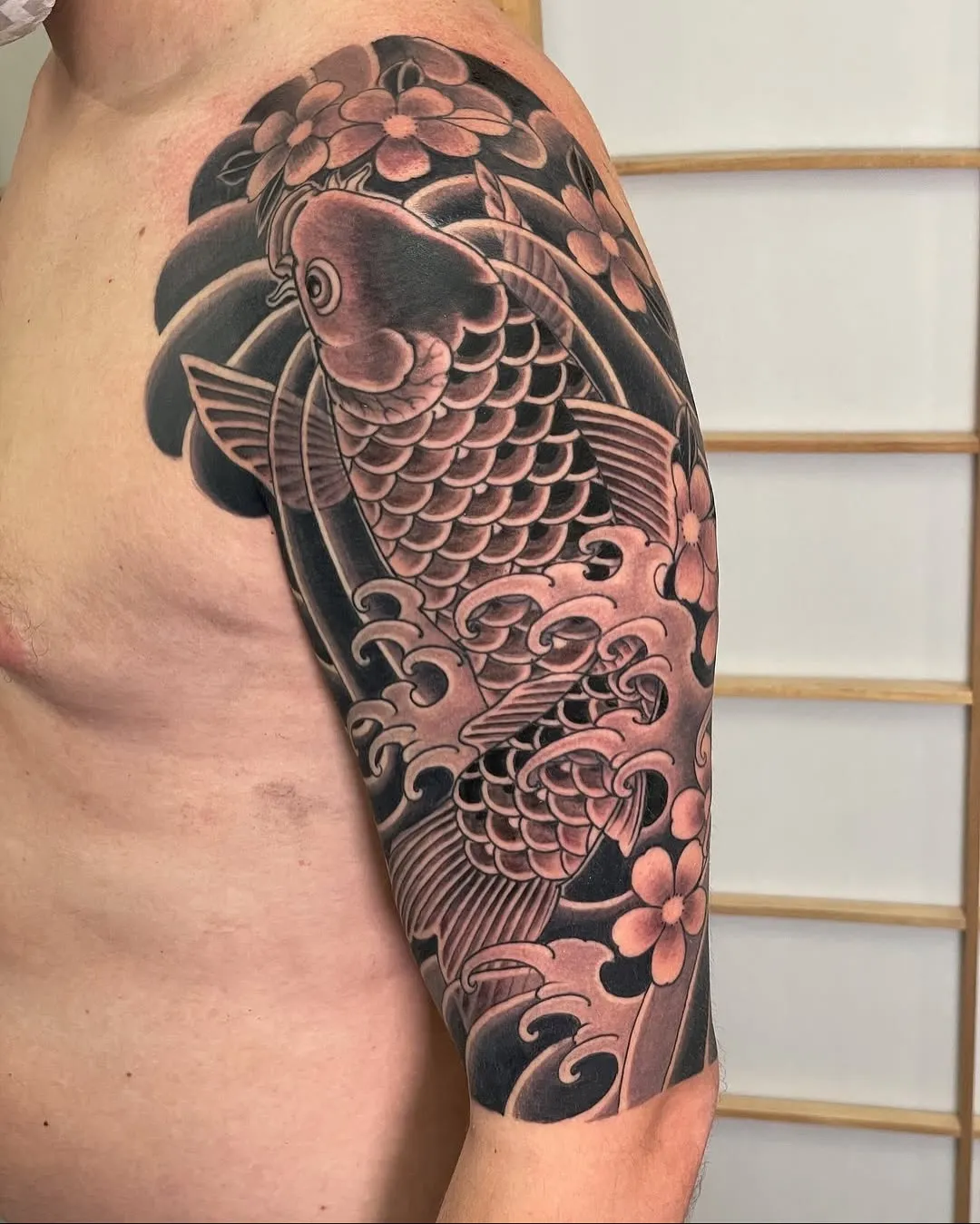 Majestic Koi in Traditional Japanese Bicep Tattoo
