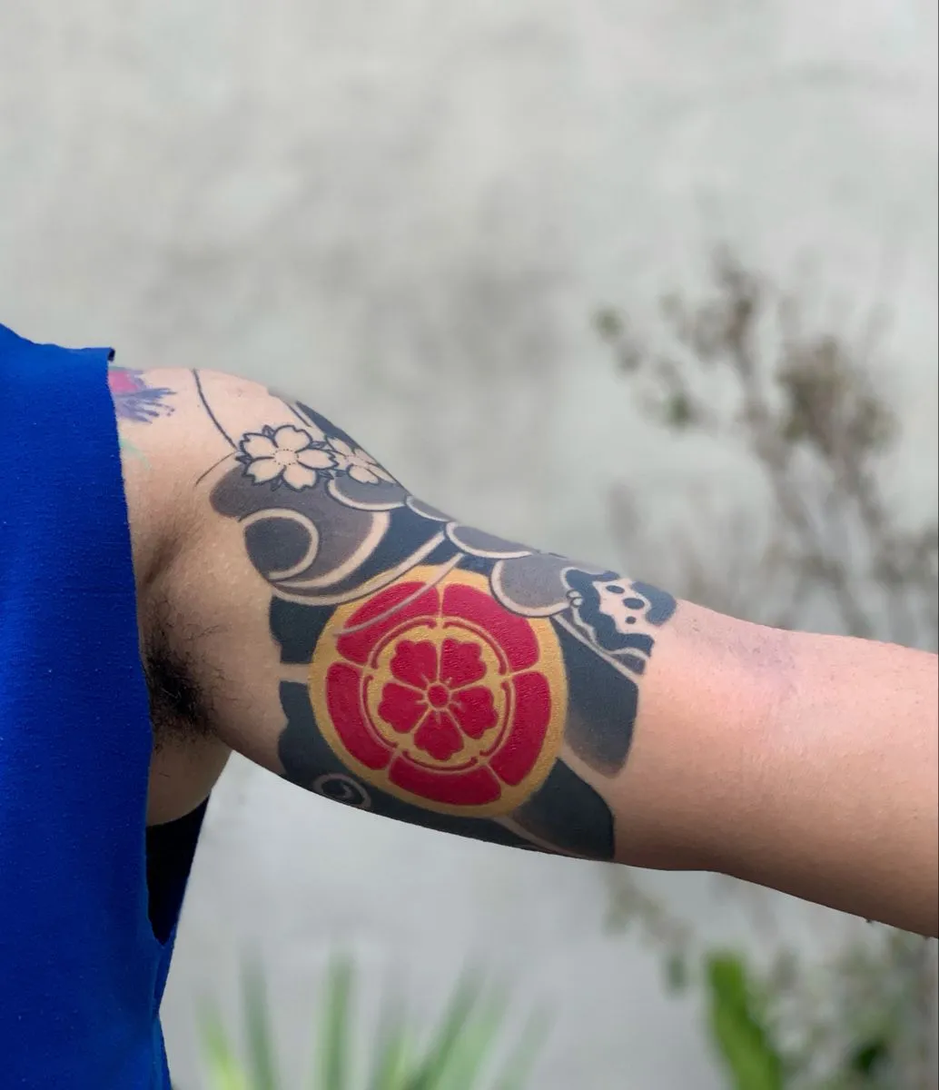 Ancient Japanese bracelet tattoo on upper arm