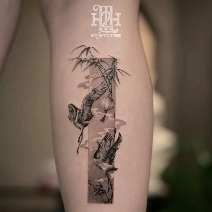 Traditional Vietnamese tattoo featuring bamboo and crane, symbolizing resilience, longevity, and peace — inked by H2M Tattoo Studio in Hanoi.