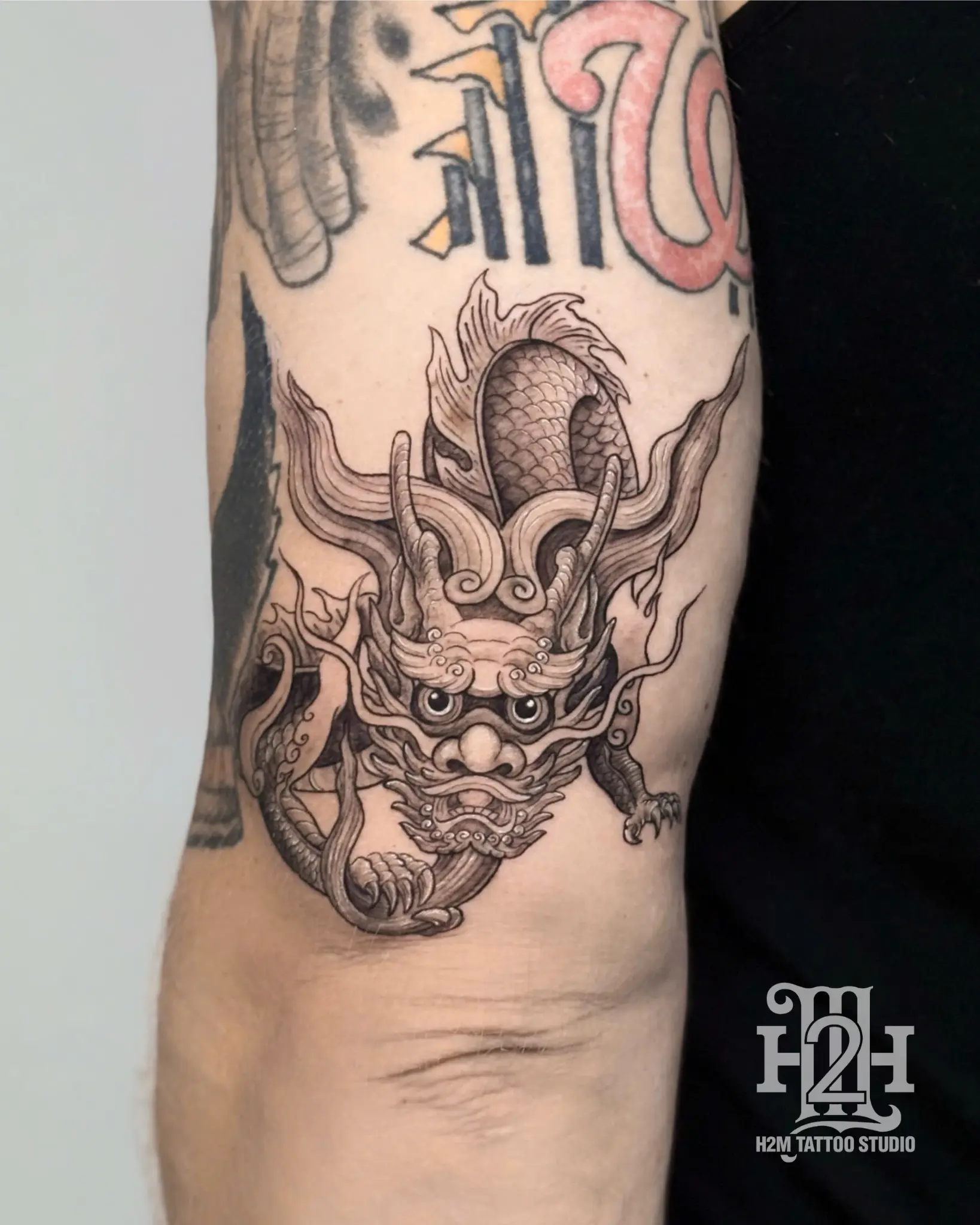 Traditional Vietnamese dragon tattoo on full back, detailed black and grey design with cultural elements