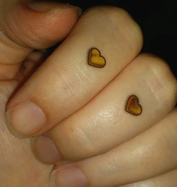 Old school gold heart tattoo