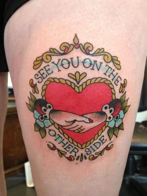 Old school heart tattoo on thigh