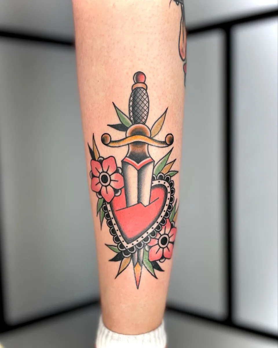 Old school heart tattoo stabbed with a dagger