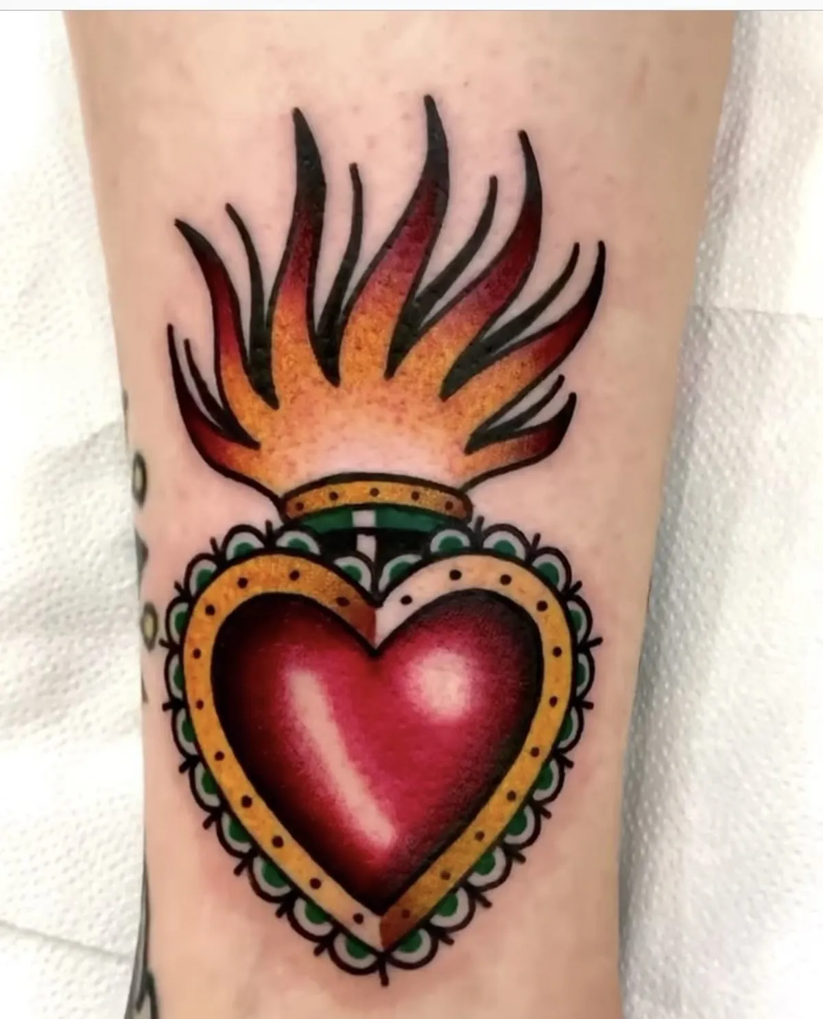 Old school fiery heart tattoo