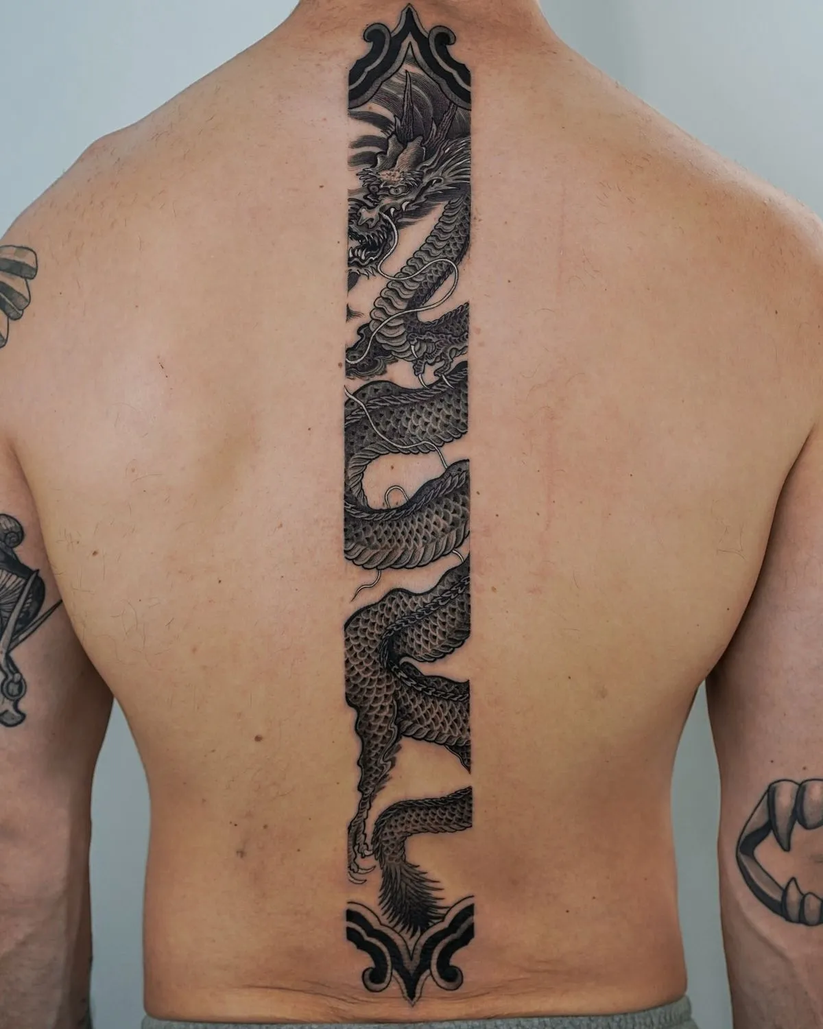 Spine Tattoos for Men: Styles, Pain & Design Ideas