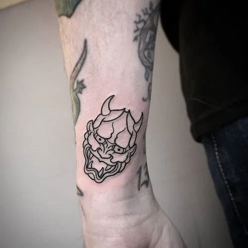Top 20+ Mini Demon Face Tattoo Designs: Subtle Protective Symbols and Embrace of Feminine Strength